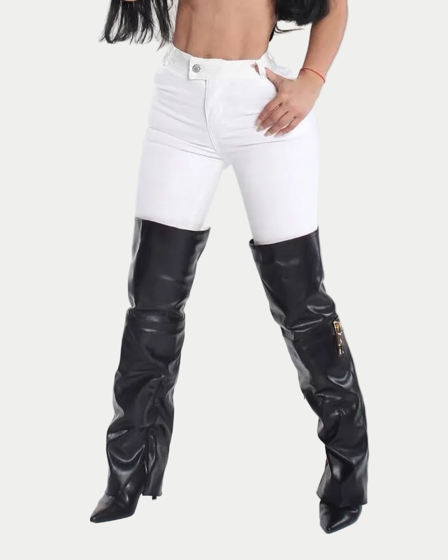 Person wearing black knee-high boots and white pants on a white background